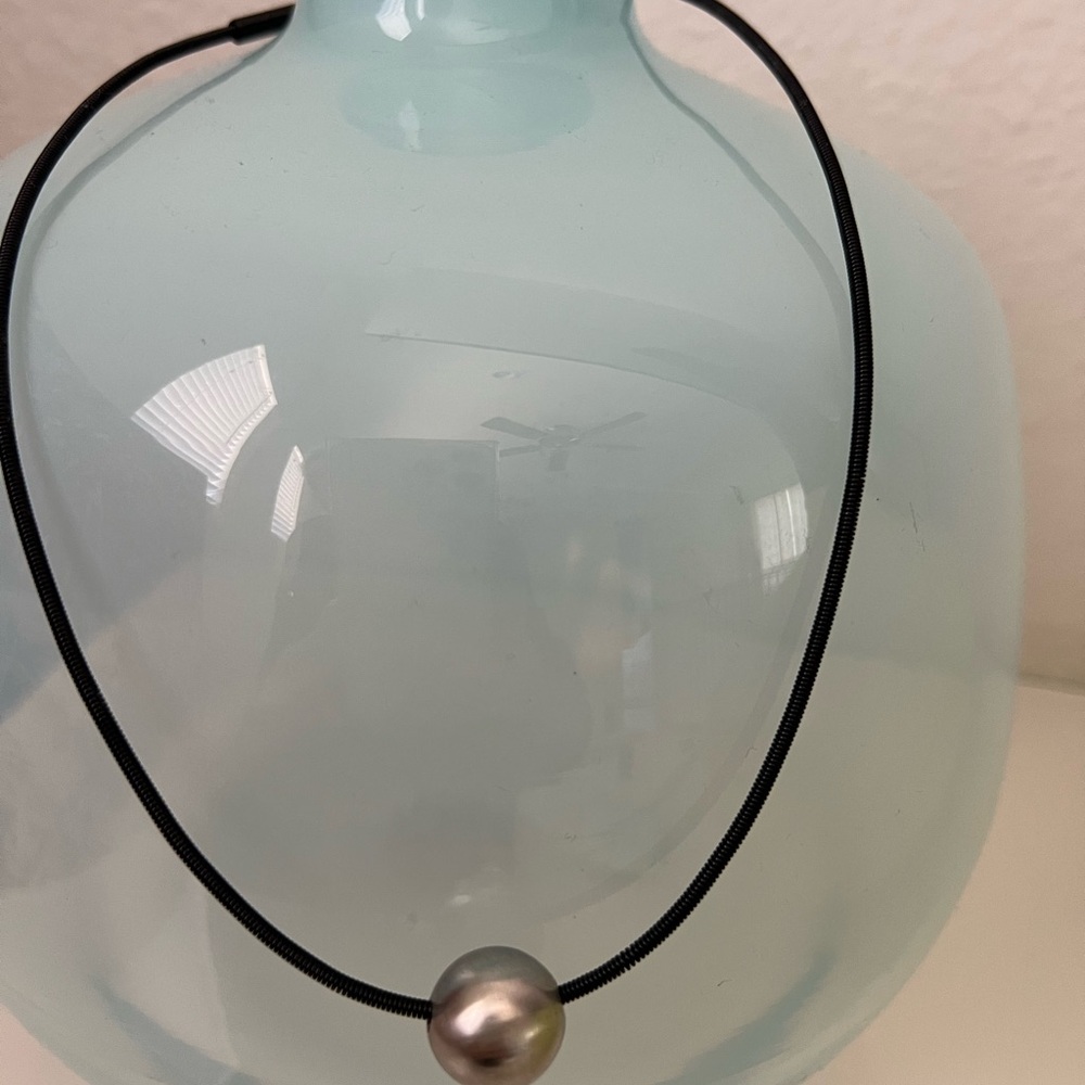 Titanium choker with rolling ball charm